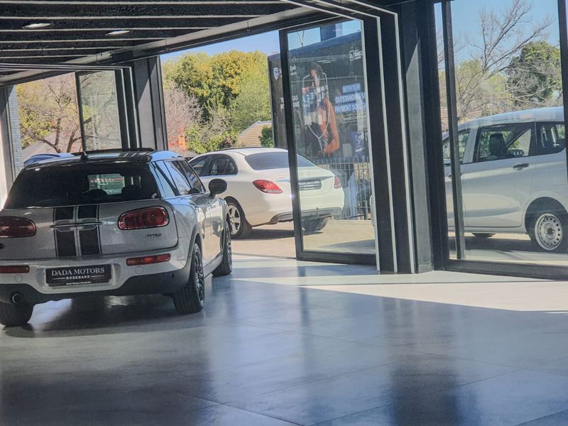 Modern commercial showroom space featuring polished concrete floors, extensive glass frontage, and high-quality structural steel framing.