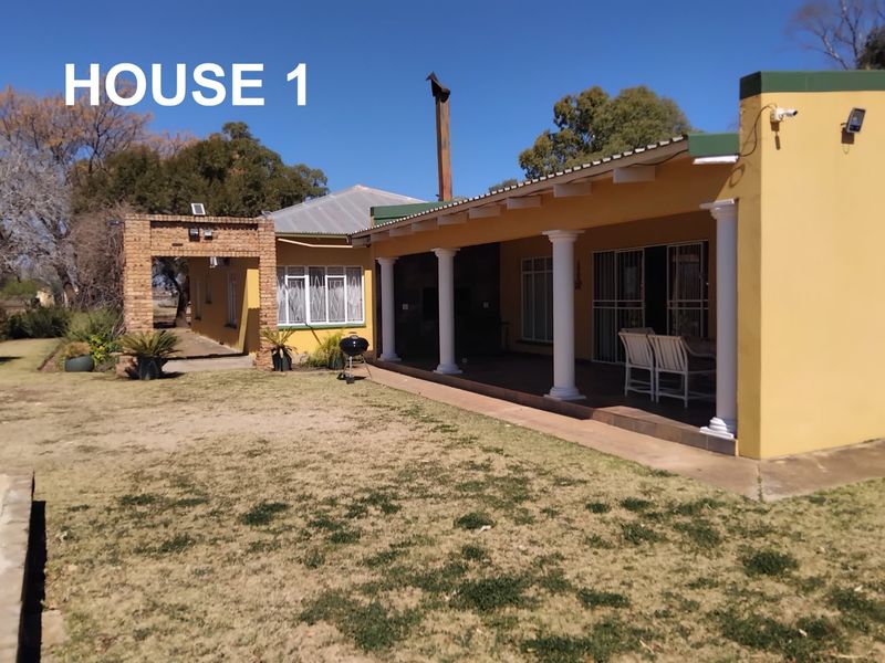 A covered patio area featuring classic columns, tiled flooring, and direct access to the garden, providing a functional outdoor living space.