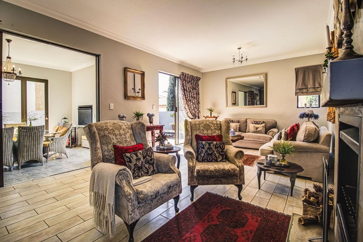 Spacious living room featuring tiled flooring, a fireplace, and large sliding glass doors providing seamless access to an adjoining patio area.