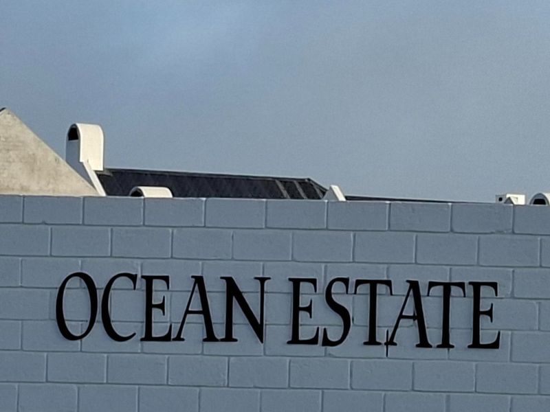 A view of the Ocean Estate boundary wall and roofline, indicating the property's location within the estate.