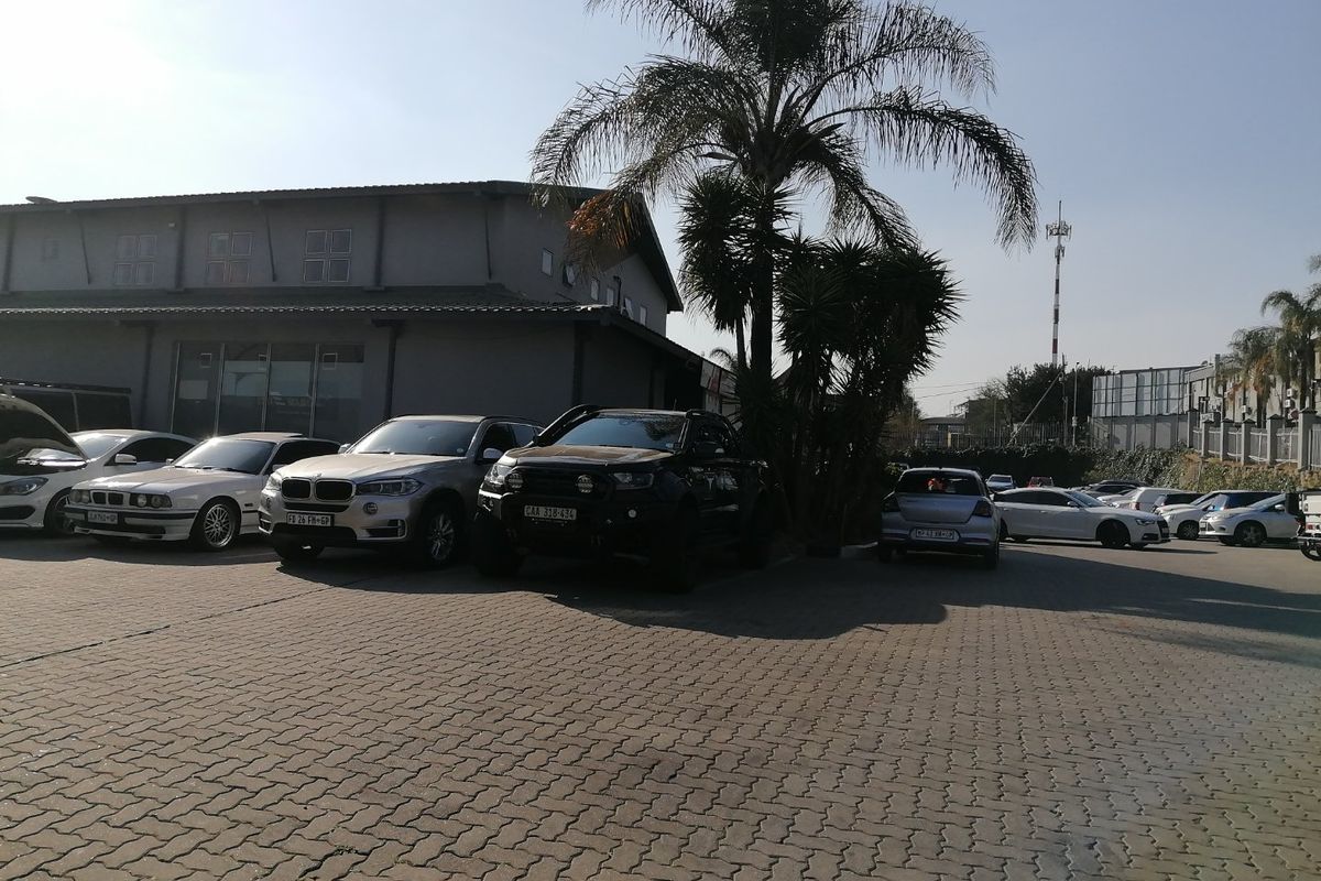 Exterior view of a commercial property featuring a paved parking area and building facade.