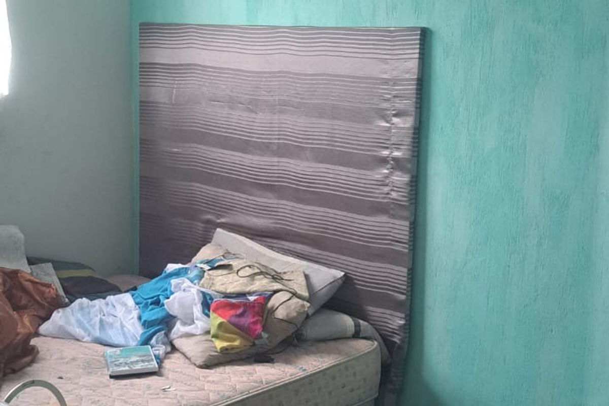 A bedroom featuring tiled flooring and textured walls, currently requiring maintenance and cosmetic updates to improve its overall condition and appeal.