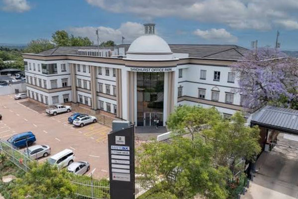 Aerial view of Sandhurst Office Park featuring a prominent domed entrance, multi-story commercial building, and dedicated paved parking area.