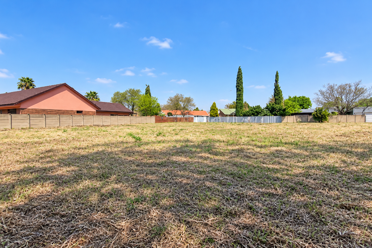 A spacious, level vacant residential plot enclosed by perimeter walls, offering a clear canvas for future development in a established neighborhood.