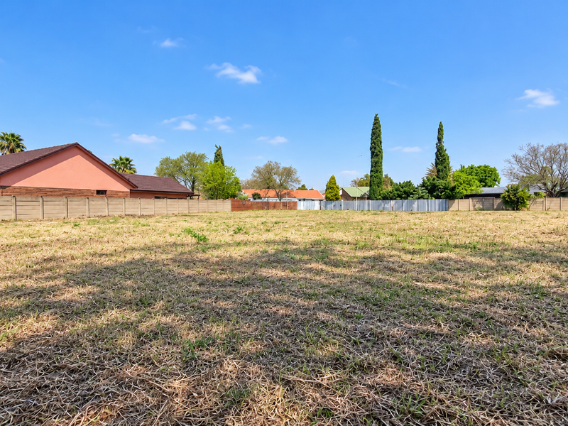 A spacious, level vacant residential plot enclosed by perimeter walls, offering a clear canvas for future development in a established neighborhood.