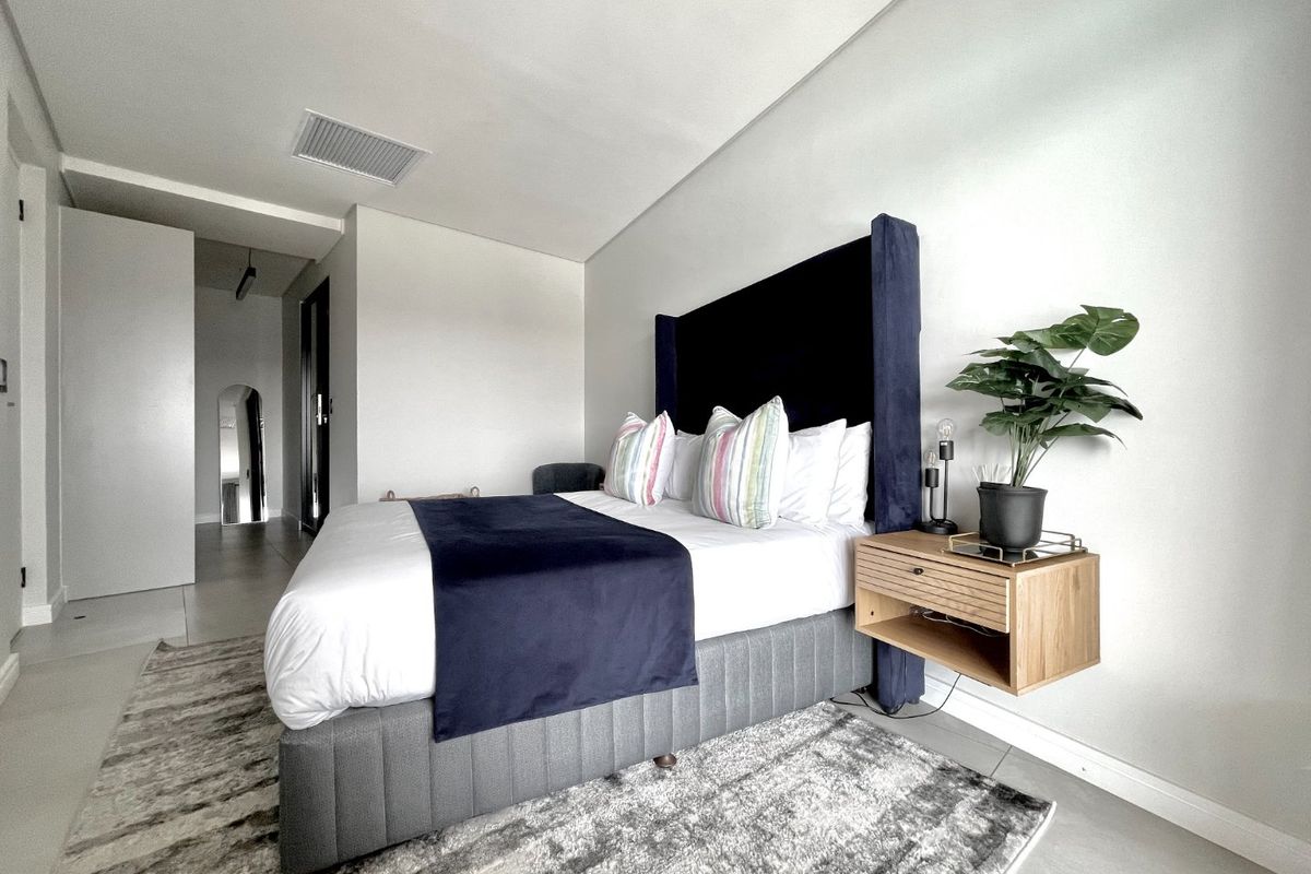 A modern, well-maintained bedroom featuring tiled flooring, recessed ceiling lighting, and integrated air conditioning, offering a clean and contemporary living space.