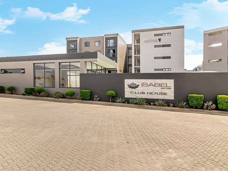 Exterior view of the modern Isabel Estate clubhouse featuring paved driveway, landscaped garden, and contemporary multi-story building architecture.
