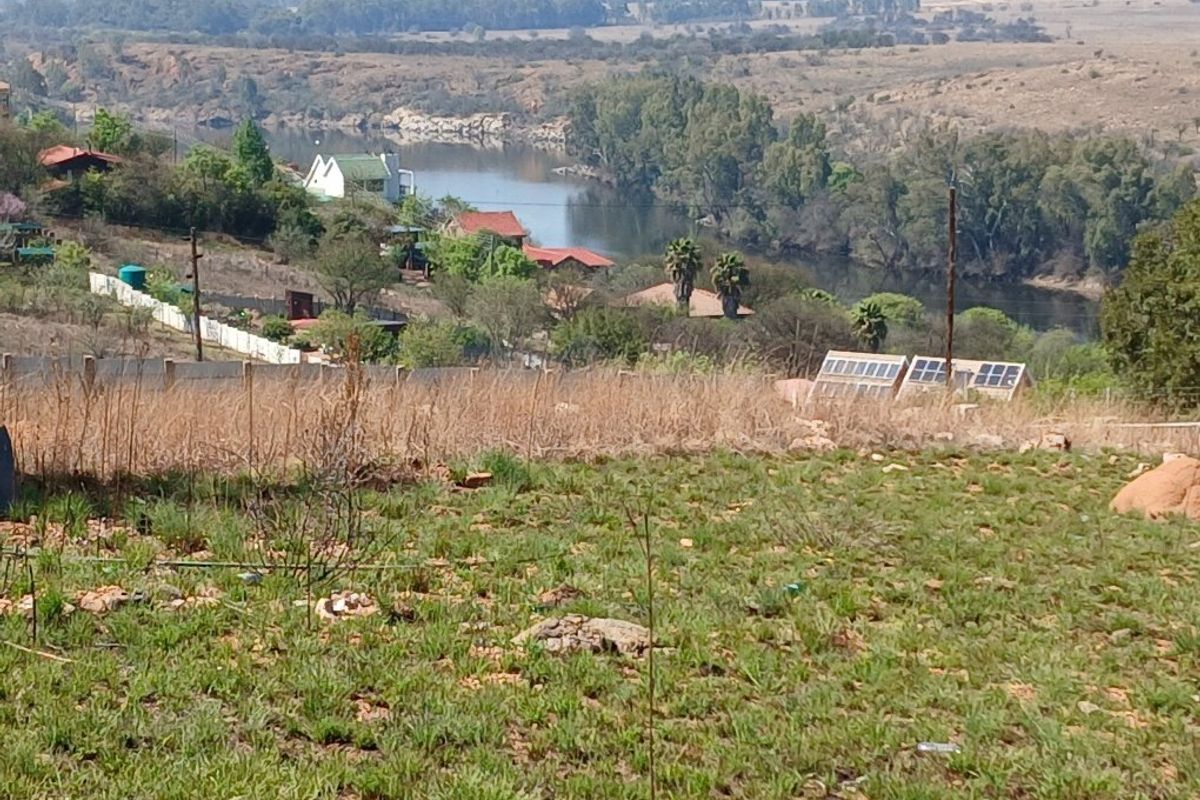 A scenic elevated view overlooking a river and surrounding natural landscape, showcasing the tranquil setting of the vacant residential land.