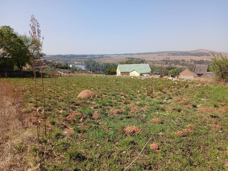 A wide-angle view of the vacant residential land overlooking the surrounding landscape and distant river.