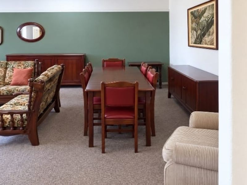 Spacious open-plan living and dining area featuring neutral carpeting and a dual-tone wall finish.