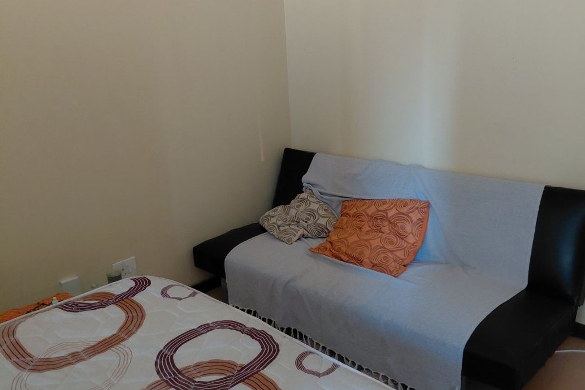 A simple bedroom space featuring neutral walls and standard electrical fixtures, suitable for a variety of bedroom configurations.