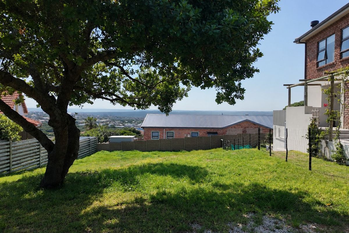 A view of the residential garden area featuring established trees, perimeter fencing, and a view of the surrounding neighborhood.