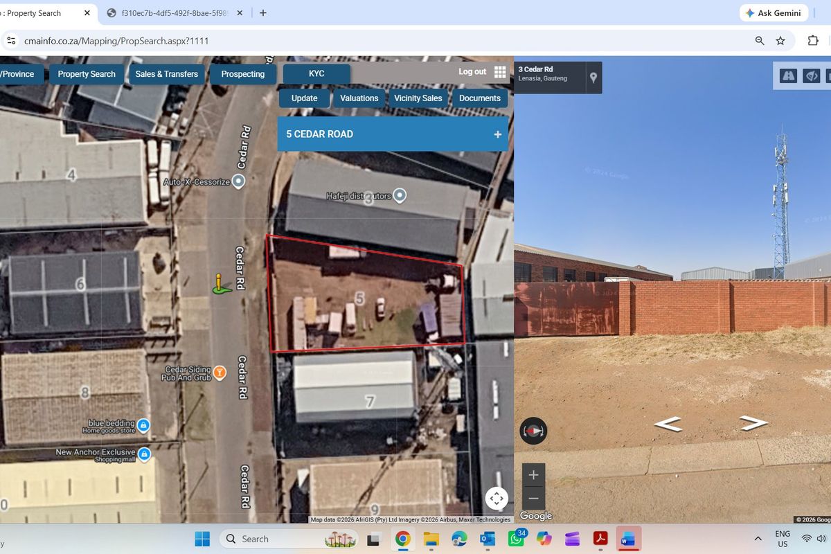 An aerial view of a vacant residential plot showing boundary walls and surrounding industrial infrastructure.