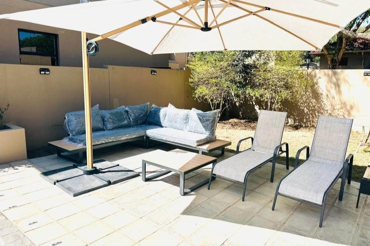 A paved outdoor patio area featuring a boundary wall, providing a functional space for relaxation and outdoor living.