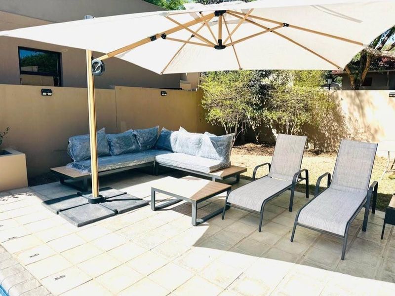 A paved outdoor patio area featuring a boundary wall, providing a functional space for relaxation and outdoor living.