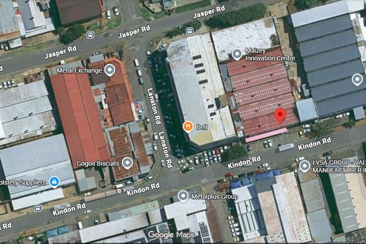 Aerial view of an industrial precinct showing warehouse facilities, street access, and parking infrastructure in an urban commercial zone.