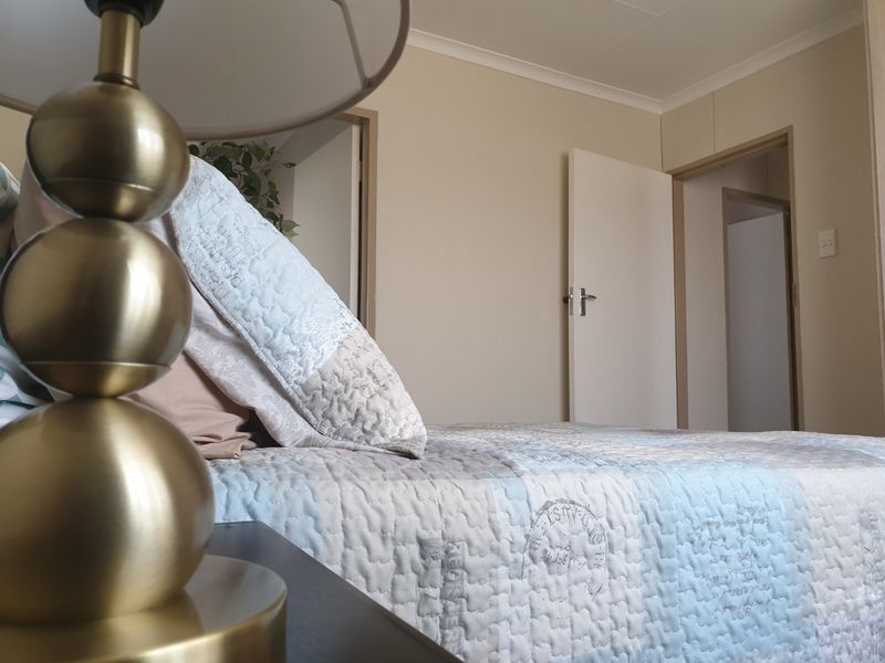 A bedroom featuring built-in cupboards and neutral wall finishes, providing a functional and well-maintained living space.
