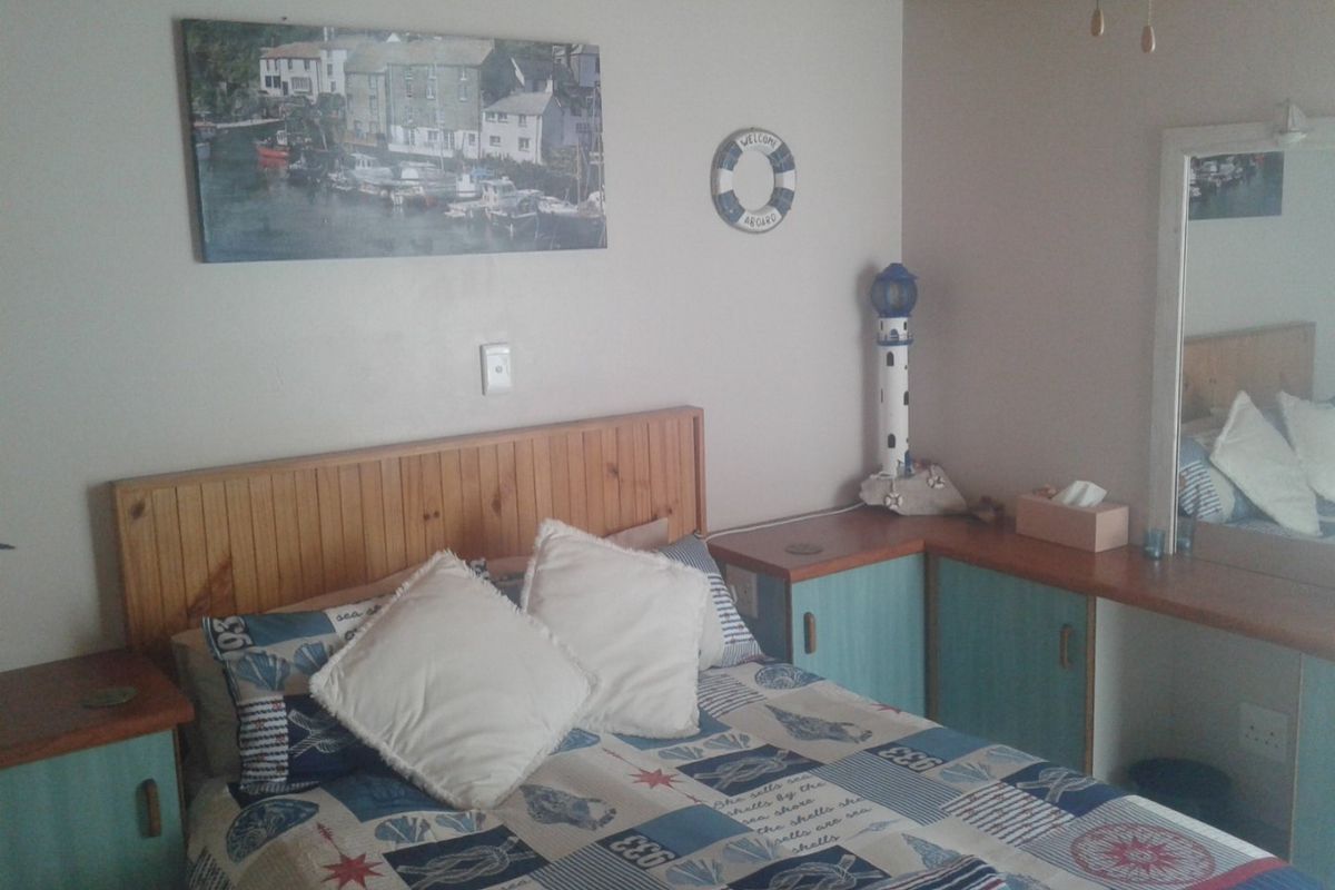 A bedroom featuring built-in timber headboard and cabinetry with a nautical theme and timber ceiling finish.