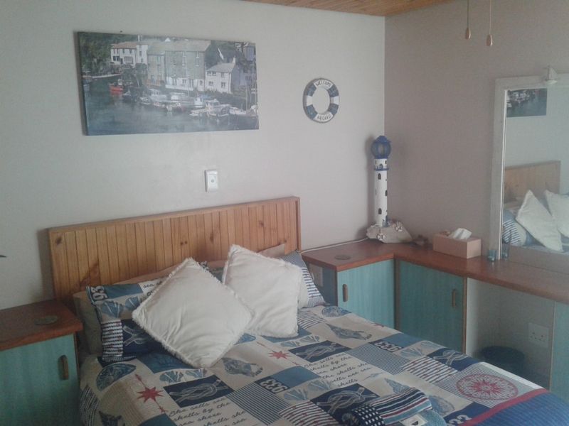 A bedroom featuring built-in timber headboard and cabinetry with a nautical theme and timber ceiling finish.