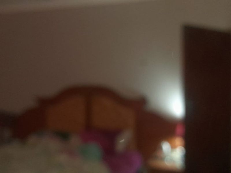 A bedroom featuring a built-in cupboard, captured in a low-quality, blurry image.