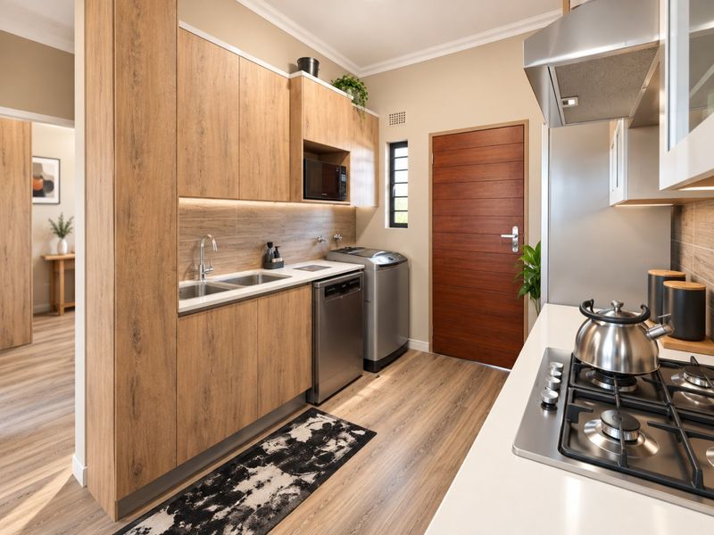 Modern kitchen featuring wood-grain cabinetry, integrated appliances, gas hob, extractor fan, and sleek countertops with under-cabinet lighting.