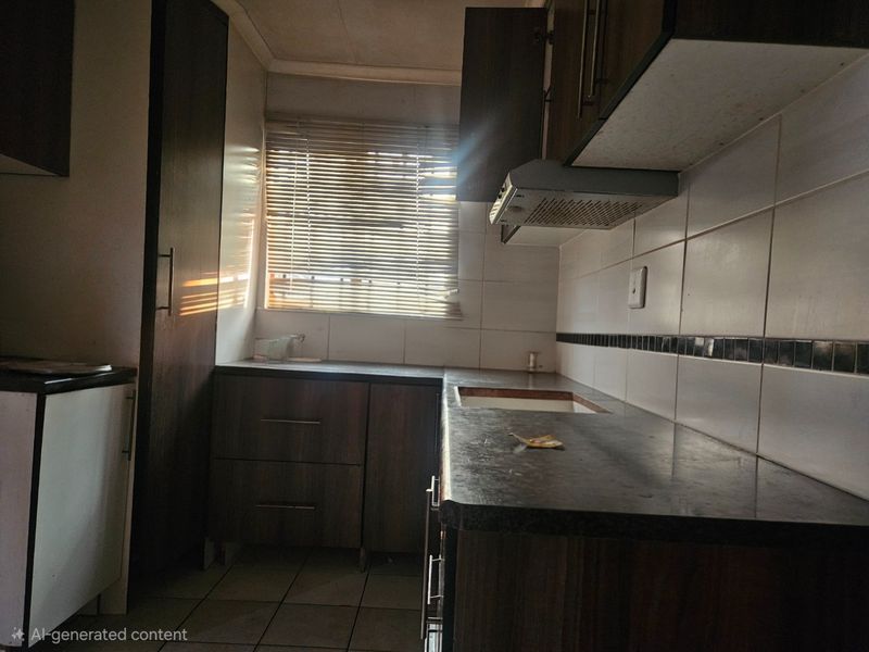 A compact kitchen featuring dark wood-look cabinetry, tiled backsplash, and laminate countertops, currently awaiting a new sink installation and modern updates.