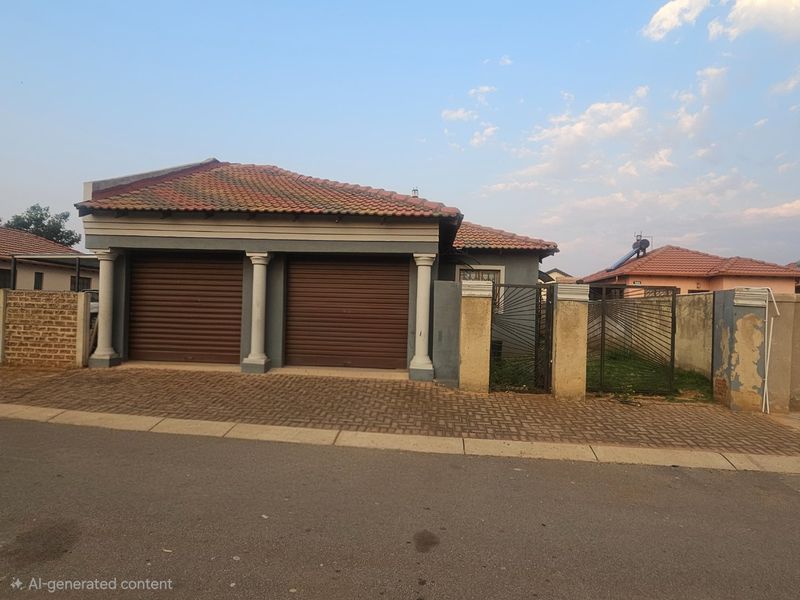 Front exterior view of a house featuring a double garage with roller shutter doors, paved driveway, and a gated entrance.