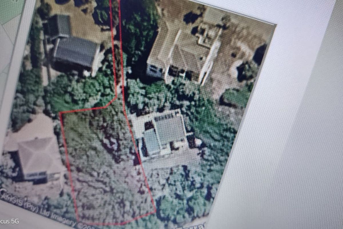 An aerial view of the residential property plot showing the land boundaries and surrounding vegetation.