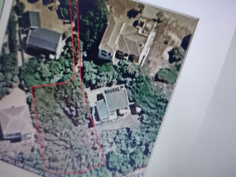 An aerial view of the residential property plot showing the land boundaries and surrounding vegetation.