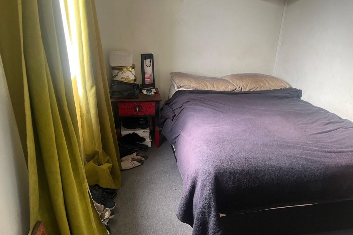 A compact bedroom featuring carpeted flooring and neutral wall finishes, offering a functional space ready for cosmetic updates.