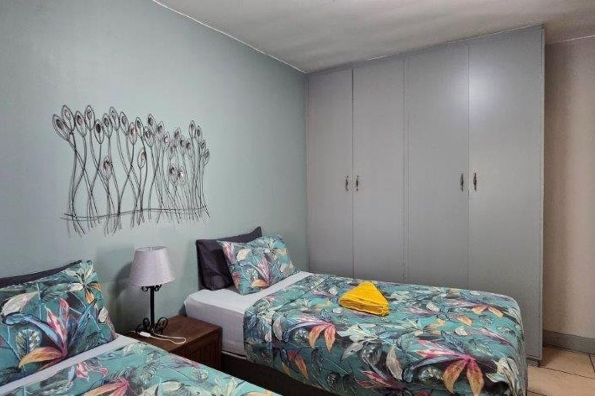 A bedroom featuring built-in cupboards and tiled flooring, providing functional storage and a neutral base for interior design.