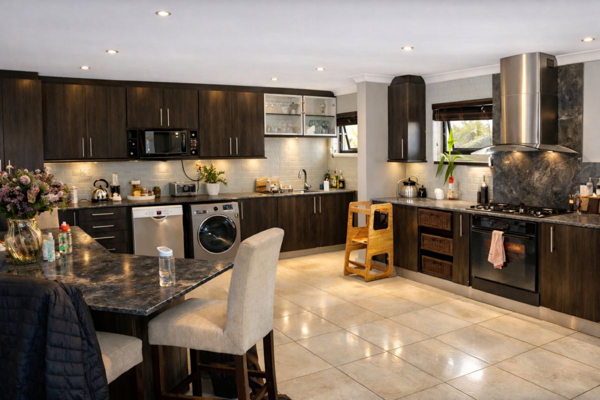 Modern kitchen featuring dark wood cabinetry, stone countertops, high-end stainless steel appliances, subway tile backsplash, and recessed lighting.