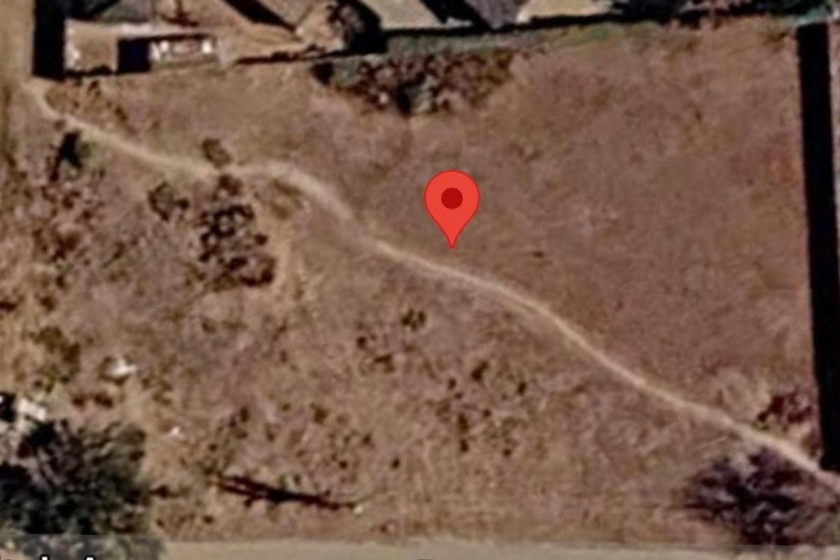 An aerial view of a vacant residential plot of land showing the site boundaries and surrounding area.