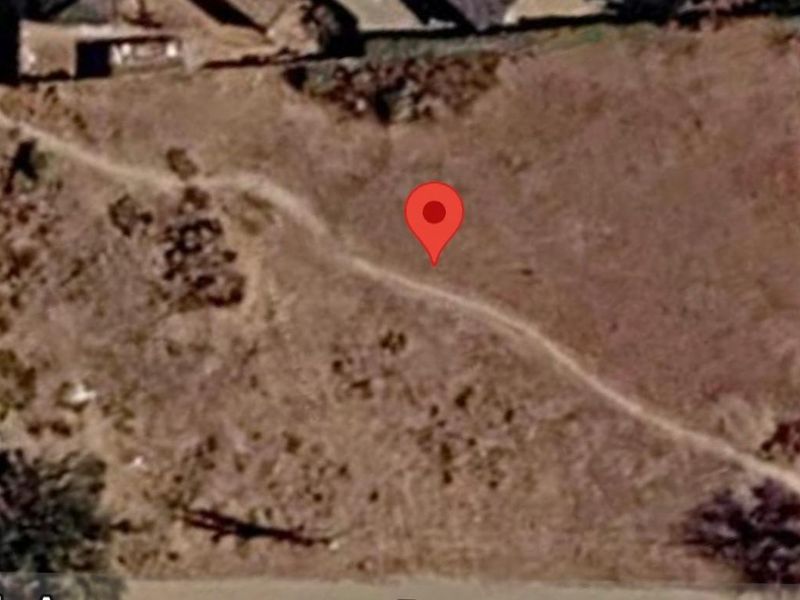An aerial view of a vacant residential plot of land showing the site boundaries and surrounding area.
