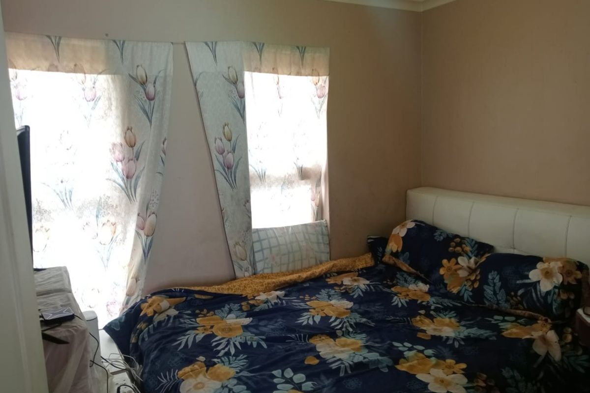 A bedroom featuring neutral wall tones and cove cornicing, requiring cosmetic updates to improve the overall finish and aesthetic appeal.