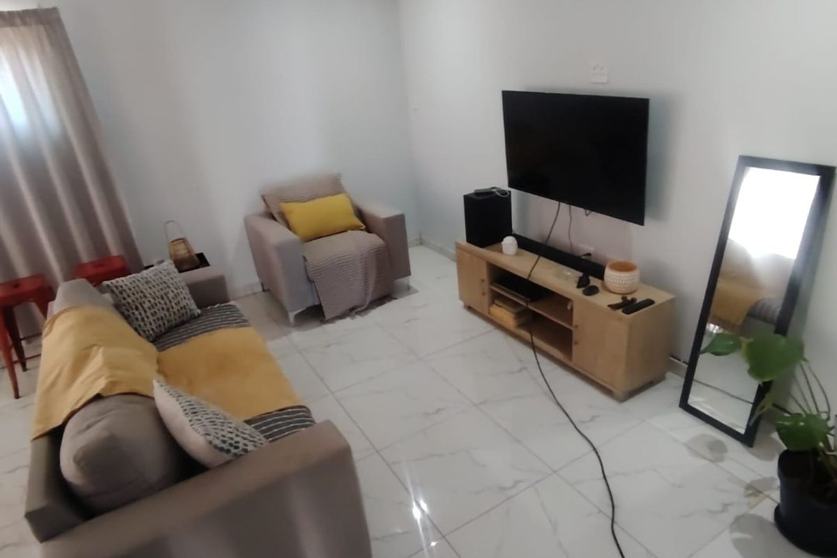A bright living room featuring modern white marble-look porcelain floor tiles and neutral wall finishes, providing a clean and contemporary foundation.