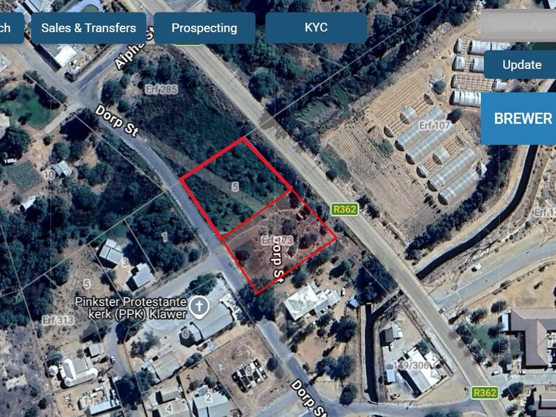 Aerial view of a vacant residential plot located on a corner, highlighting the property boundaries and surrounding street layout.