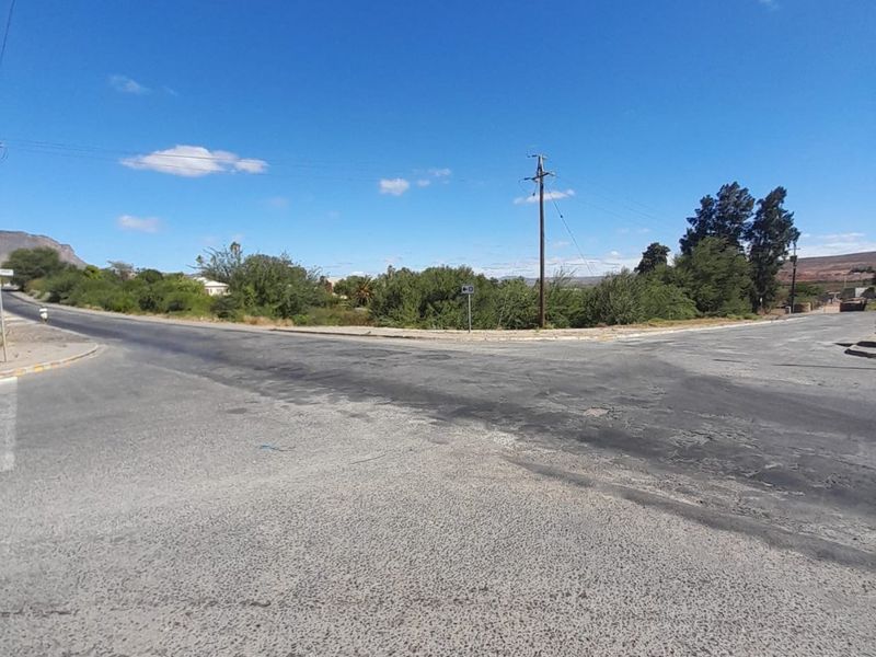 A street-level view of the intersection adjacent to the vacant residential land, showing existing road infrastructure and utility access.