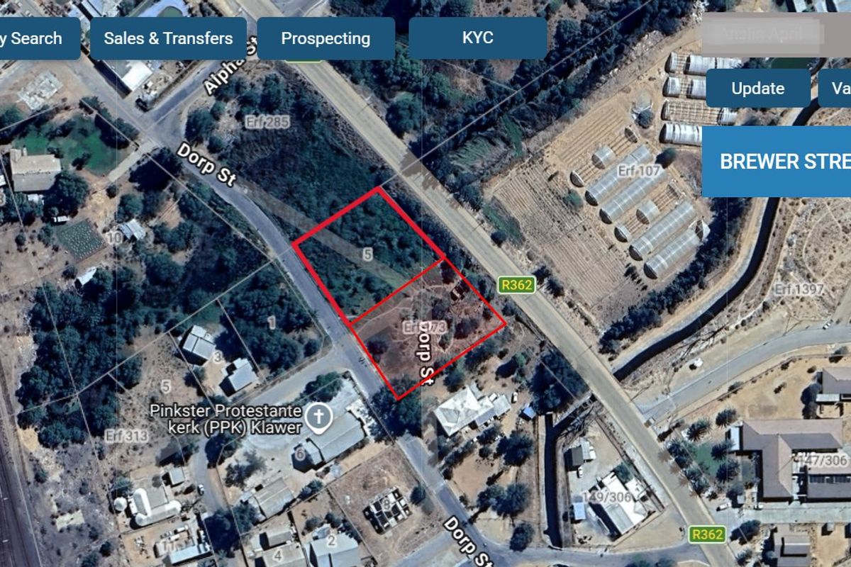Aerial view of a vacant residential plot located on a corner, highlighting the property boundaries and surrounding street layout.