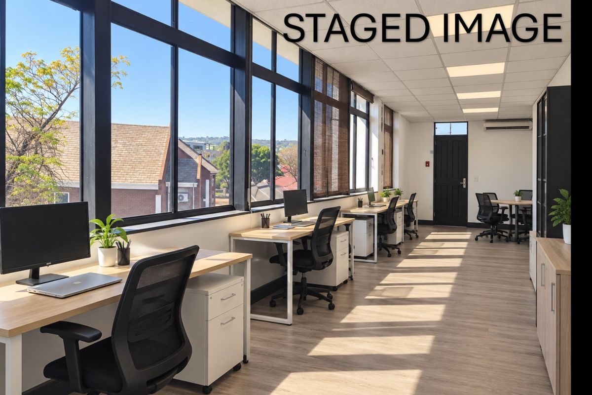 Modern commercial office space featuring large windows, suspended ceilings, recessed lighting, and air conditioning, providing a bright and professional work environment.