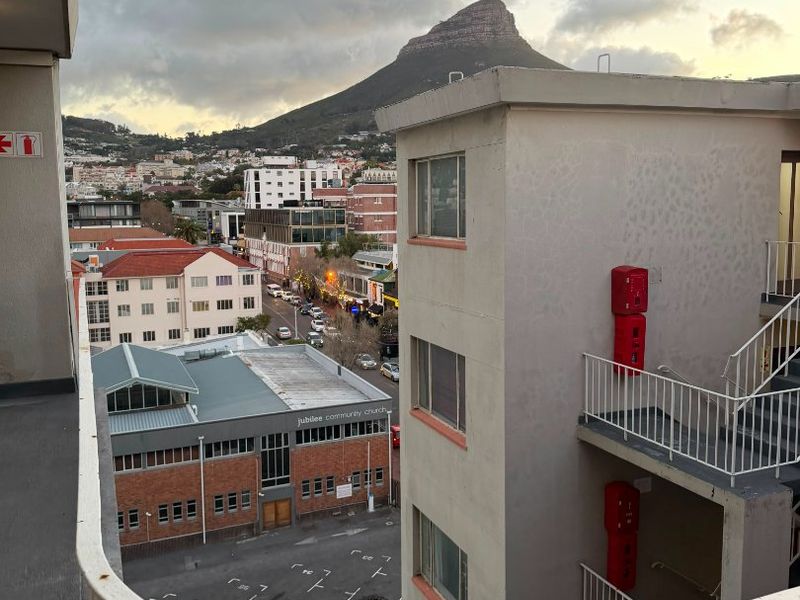 Elevated urban view overlooking the neighbourhood and surrounding buildings, featuring a clear perspective of the mountain landscape.