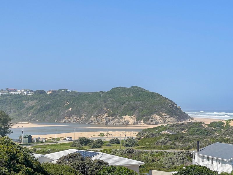 Elevated coastal view overlooking the estuary, dunes, and ocean, showcasing the scenic natural landscape surrounding the property.