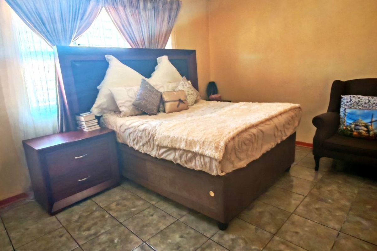 A bedroom featuring tiled flooring and a central ceiling light fixture, providing a functional space with standard finishes.