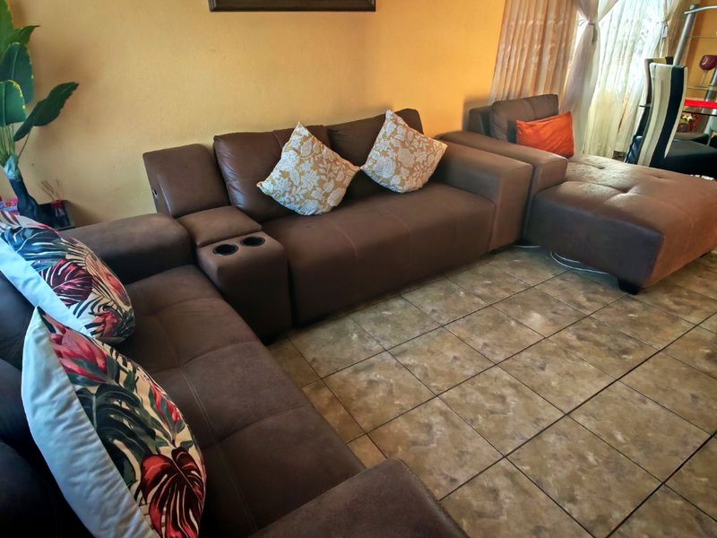 A living room area featuring tiled flooring and neutral wall finishes.