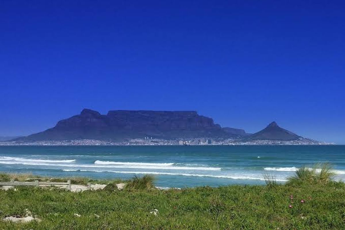 A scenic view of the ocean with Table Mountain in the background, showcasing the natural landscape and coastal setting of the property.