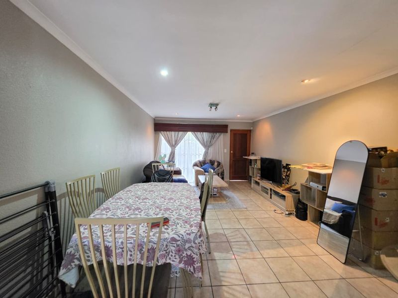 Open plan living and dining area featuring tiled flooring, coved ceilings, and recessed lighting, providing a functional space for daily living.