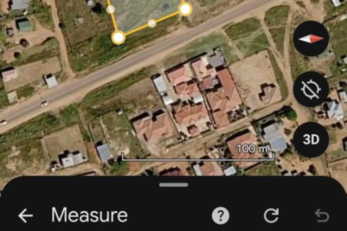 An aerial view of a vacant residential plot measuring approximately 1,687 square meters, suitable for future development.