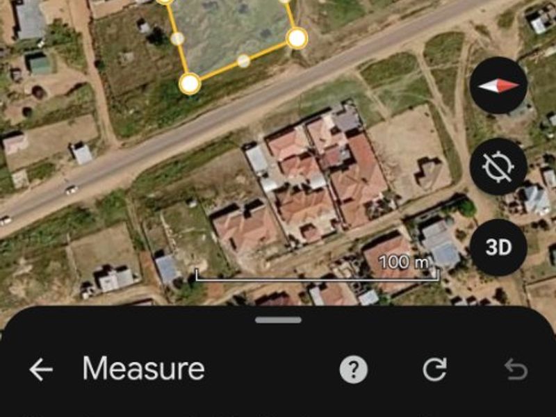 An aerial view of a vacant residential plot measuring approximately 1,687 square meters, suitable for future development.