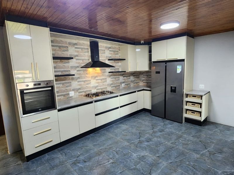 Modern kitchen featuring built-in cabinetry, gas hob, extractor fan, integrated oven, stone-look splashback, and timber-clad ceiling with tiled flooring.