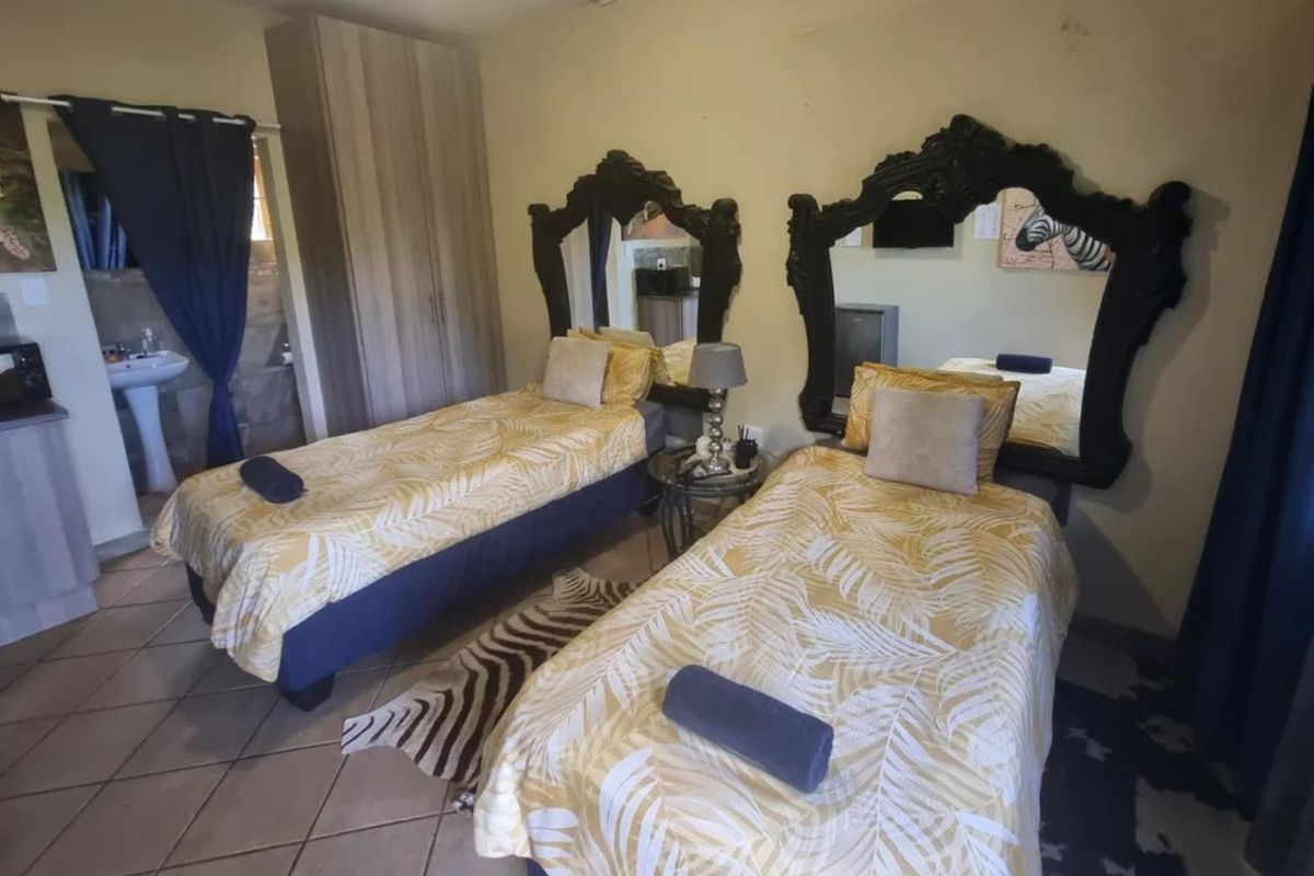 A bedroom featuring tiled flooring, a built-in wardrobe, and an integrated wash basin area, requiring cosmetic updates to improve the overall finish.